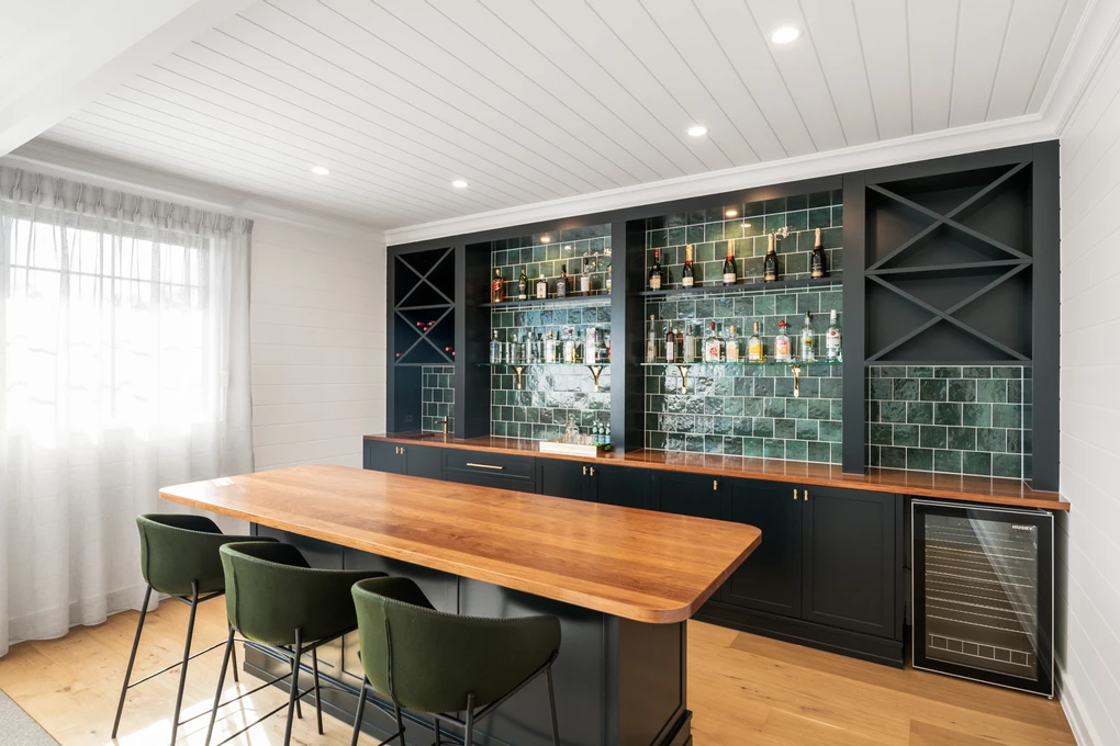 Custom bar joinery with emerald accents