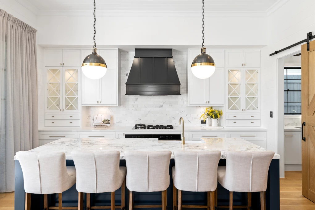 Modern kitchen with dark blue island and window treatments